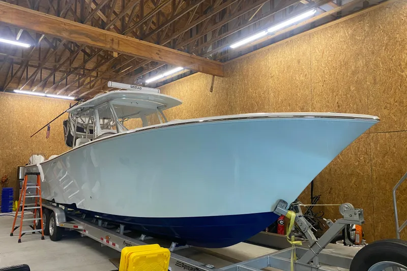 Slide: The Image of 2022 Front Runner 39 CC boat in a wooden garage on a trailer. - 8