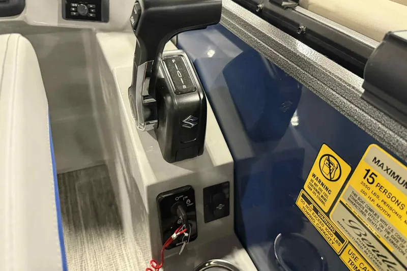 Slide: The Image of 2026 Bentley Pontoons Legacy 223 Navigator control panel with throttle and warning labels. - 10