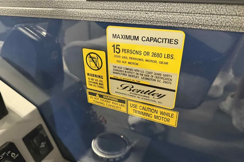 Slide: The Image of Sticker on 2026 Bentley Pontoons Legacy 223 Navigator, showing maximum capacities and safety warnings. - 11