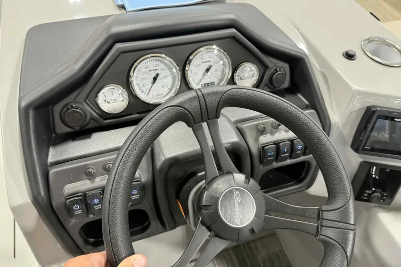 Slide: The Image of Steering console of 2026 Bentley Pontoons Legacy 223 Navigator Full Tube with gauges and controls. - 18
