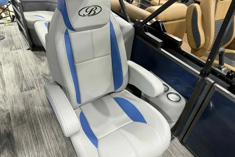 Slide: The Image of Luxurious seating in 2026 Bentley Pontoons Legacy 223 Navigator, featuring blue and gray upholstery. - 21