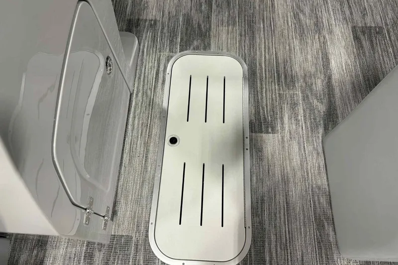 Slide: The Image of 2026 Bentley Pontoons Legacy 223 Navigator interior flooring and storage compartment. - 3