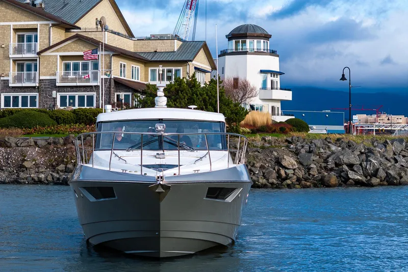 Slide: The Image of 2014 Cruisers Yachts 45 Cantius in scenic harbor with coastal buildings. - 10