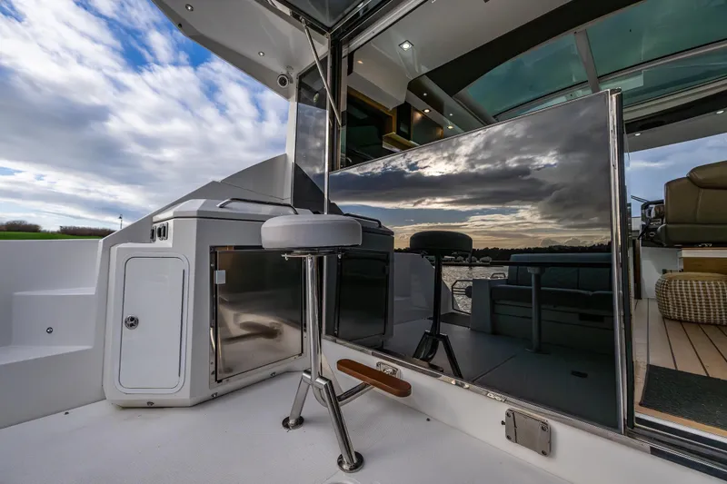 Slide: The Image of 2014 Cruisers Yachts 45 Cantius cockpit with sleek seating and reflective surfaces. - 15