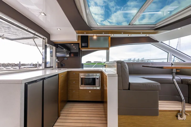 Slide: The Image of Luxurious interior of 2014 Cruisers Yachts 45 Cantius with modern kitchen and seating area. - 18