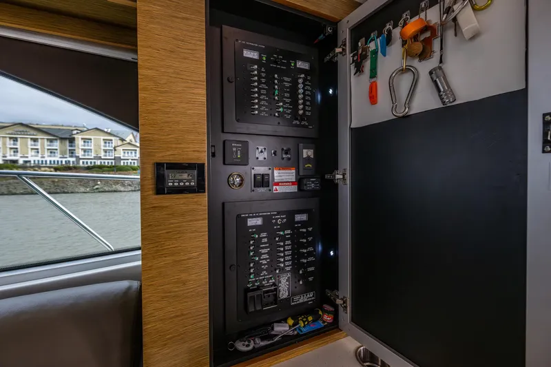 Slide: The Image of Electrical panel inside 2014 Cruisers Yachts 45 Cantius, with organized tools and controls. - 21