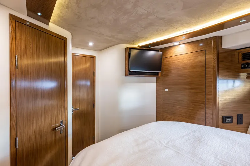 Slide: The Image of Interior of 2014 Cruisers Yachts 45 Cantius with wood paneling and mounted TV. - 28
