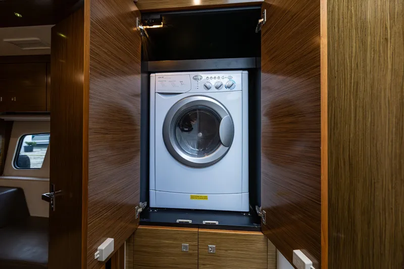 Slide: The Image of Washing machine inside 2014 Cruisers Yachts 45 Cantius wooden cabinet. - 47