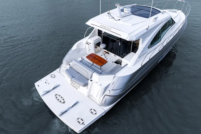 Slide: The Image of 2014 Cruisers Yachts 45 Cantius on water, showcasing sleek design and spacious deck. - 48