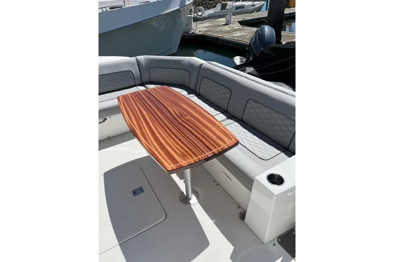 Slide: The Image of 2014 Cruisers Yachts 45 Cantius interior with wooden table and cushioned seating. - 7