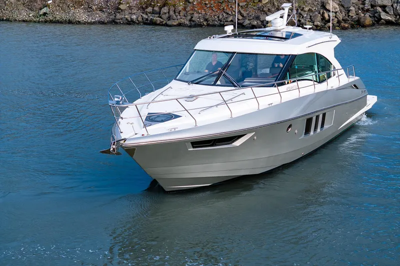 Slide: The Image of 2014 Cruisers Yachts 45 Cantius navigating calm waters, showcasing sleek design and luxury. - 9
