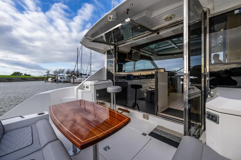 Slide: The Image of 2014 Cruisers Yachts 45 Cantius with elegant interior and outdoor seating on a sunny day. - 14