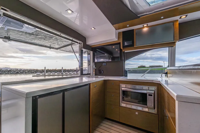 Slide: The Image of Luxurious 2014 Cruisers Yachts 45 Cantius kitchen with modern appliances and scenic water view. - 19