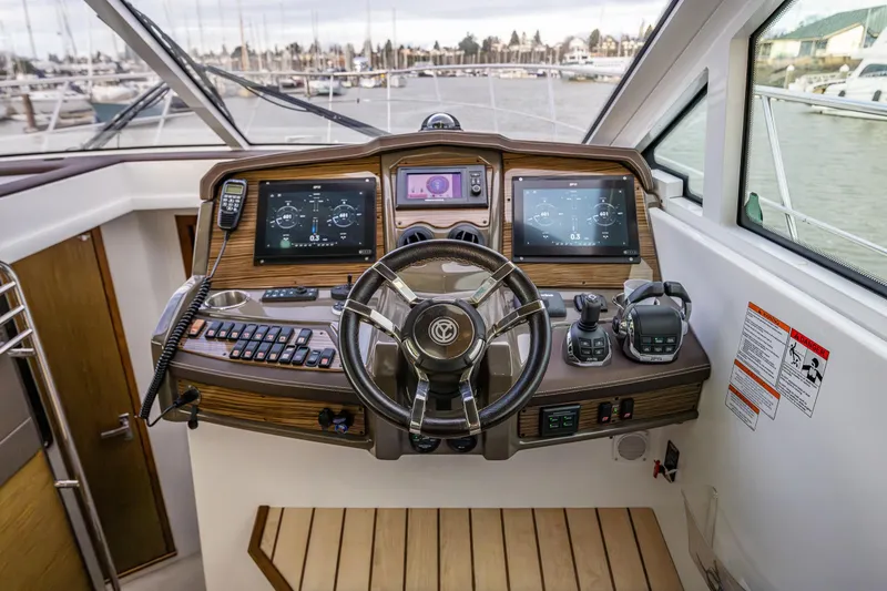 Slide: The Image of Helm of 2014 Cruisers Yachts 45 Cantius with advanced navigation controls and displays. - 22