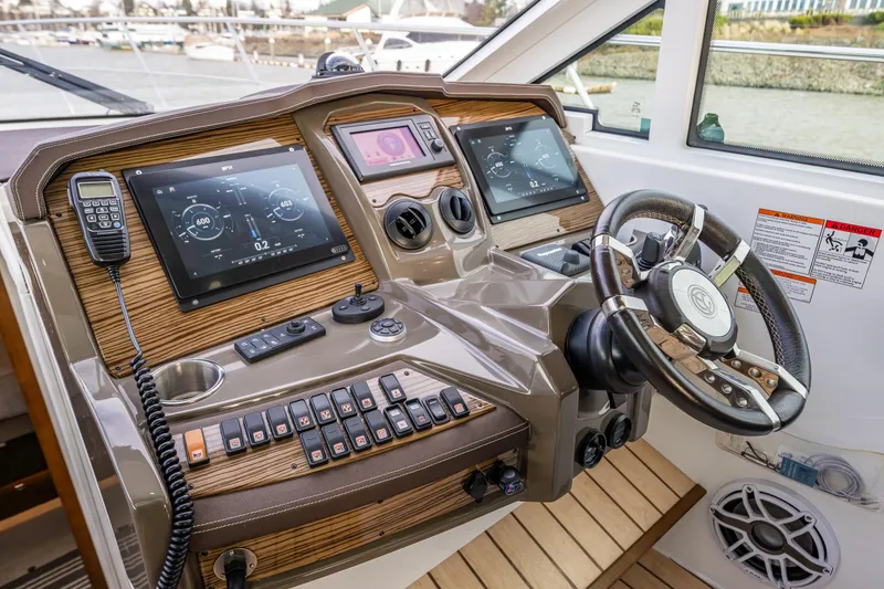 Slide: The Image of Helm of 2014 Cruisers Yachts 45 Cantius with advanced navigation controls and steering wheel. - 23