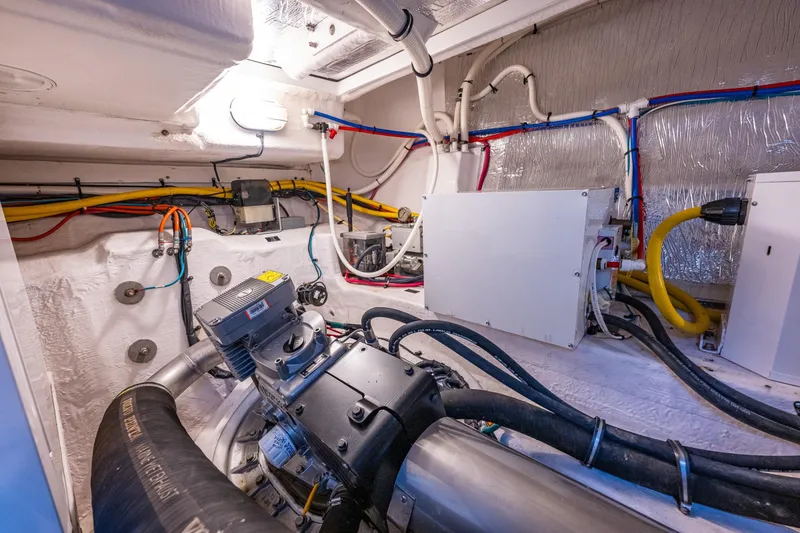 Slide: The Image of Engine room of 2014 Cruisers Yachts 45 Cantius with visible wiring and machinery. - 43