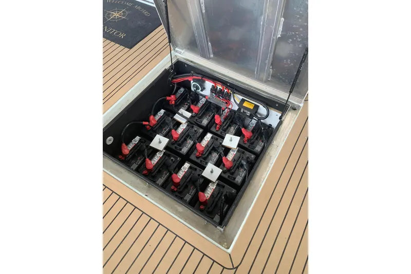 Slide: The Image of Battery compartment of 2023 Sumerset 18 x 81 houseboat, featuring multiple batteries and wiring. - 10