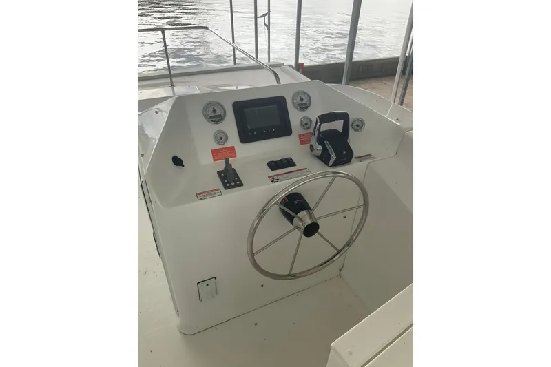 Slide: The Image of Helm of 2023 Sumerset 18 x 81 houseboat with steering wheel and controls. - 14