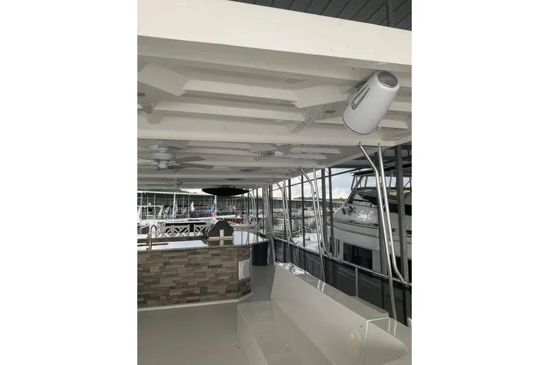 Slide: The Image of 2023 Sumerset 18 x 81 houseboat interior with ceiling fans and outdoor seating. - 16