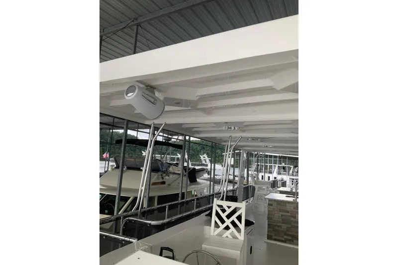 Slide: The Image of 2023 Sumerset 18 x 81 houseboat interior with modern design and outdoor seating area. - 17