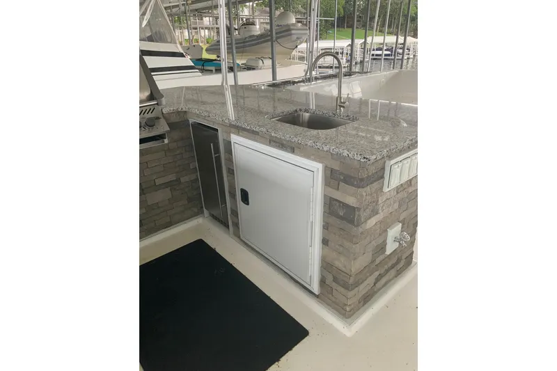 Slide: The Image of Outdoor kitchen area on 2023 Sumerset 18 x 81 houseboat with granite countertop and sink. - 22