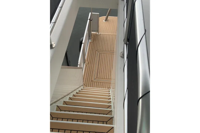 Slide: The Image of Staircase on 2023 Sumerset 18 x 81 houseboat with sleek wooden deck design. - 25