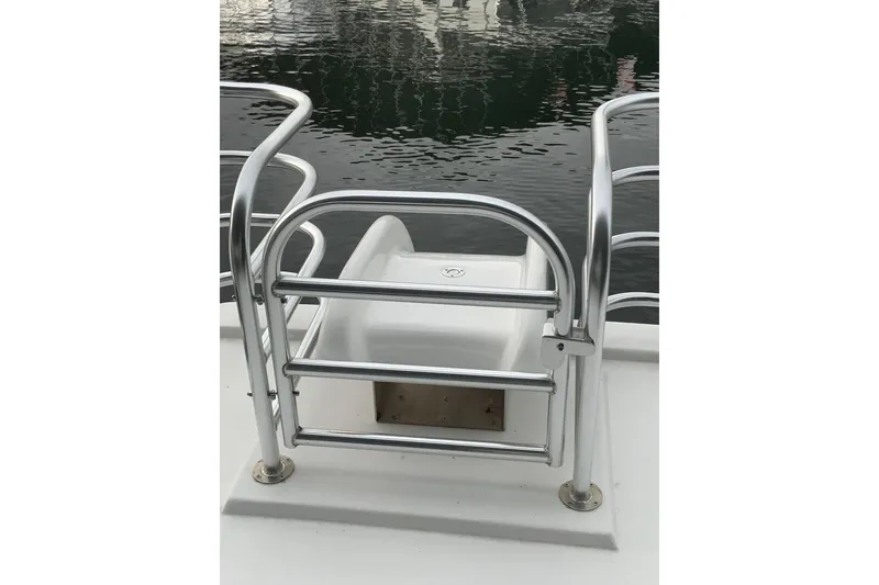 Slide: The Image of Stainless steel railing on 2023 Sumerset 18 x 81 houseboat deck by water. - 26