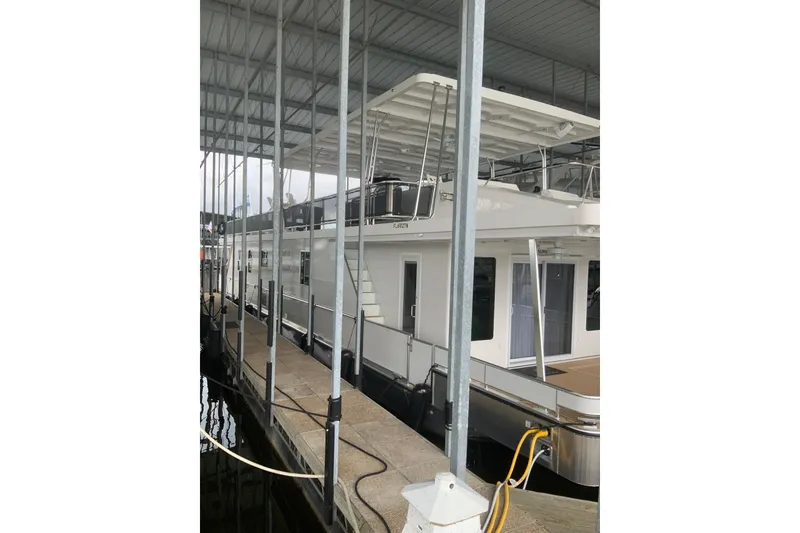 Slide: The Image of 2023 Sumerset 18 x 81 houseboat docked under covered marina. - 3