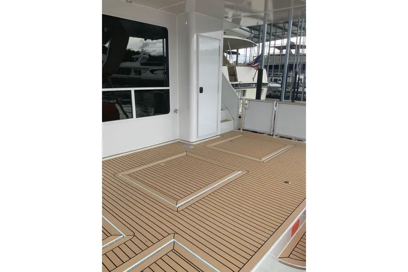 Slide: The Image of 2023 Sumerset 18 x 81 houseboat deck with modern design and wood-like flooring. - 32