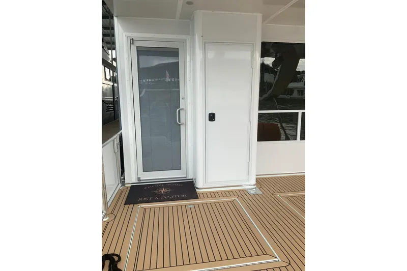 Slide: The Image of 2023 Sumerset 18 x 81 houseboat entrance with sleek door and welcome mat. - 34
