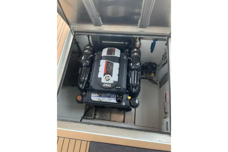 Slide: The Image of Engine compartment of 2023 Sumerset 18 x 81 houseboat, featuring a 4.5L 250 horsepower engine. - 36