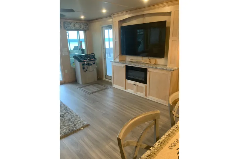 Slide: The Image of Luxurious 2023 Sumerset 18 x 81 houseboat interior with modern entertainment center and helm. - 44