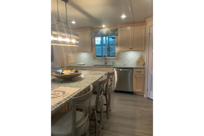Slide: The Image of Modern kitchen in 2023 Sumerset 18 x 81 houseboat with granite countertops and stylish lighting. - 45