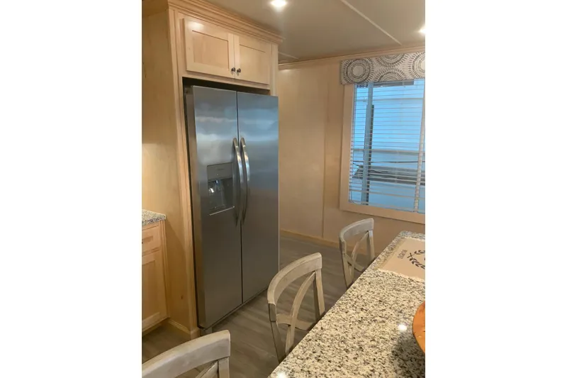 Slide: The Image of Modern kitchen in 2023 Sumerset 18 x 81 houseboat with stainless steel refrigerator. - 48