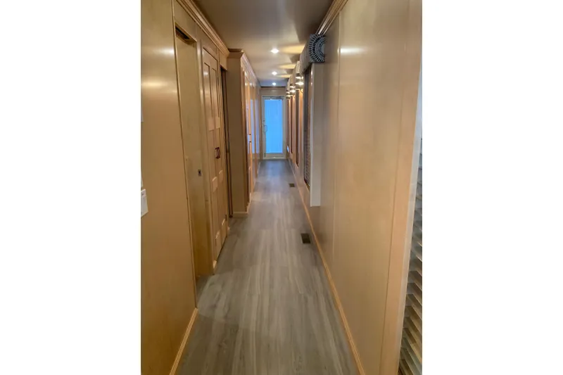 Slide: The Image of Hallway of 2023 Sumerset 18 x 81 houseboat with wooden paneling and flooring. - 53
