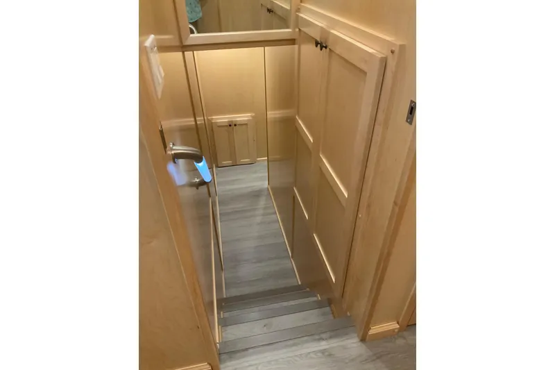 Slide: The Image of Staircase in 2023 Sumerset 18 x 81 houseboat with wooden paneling and modern design. - 54