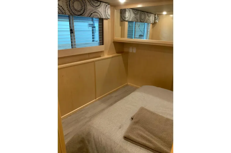 Slide: The Image of Bedroom interior of 2023 Sumerset 18 x 81 houseboat with window and bed. - 56