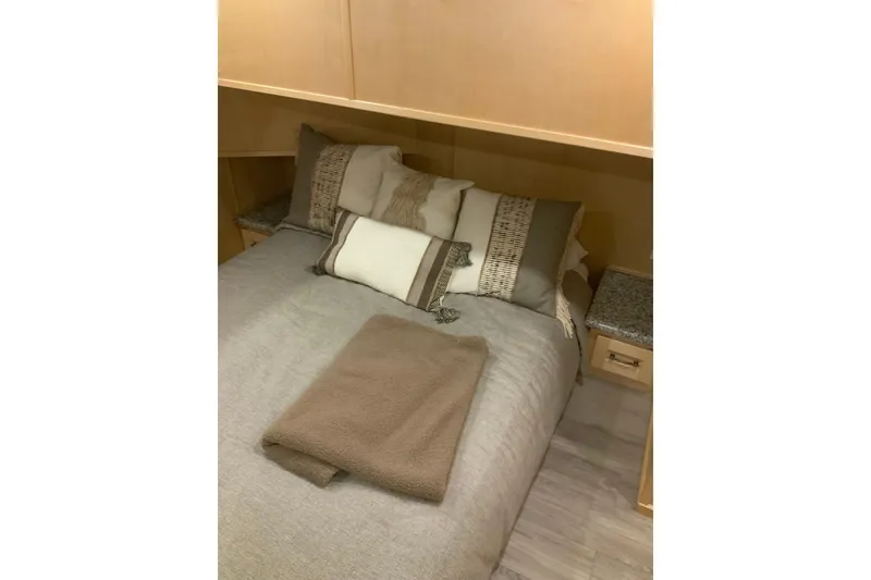 Slide: The Image of Cozy bedroom in 2023 Sumerset 18 x 81 houseboat with neutral bedding and pillows. - 57