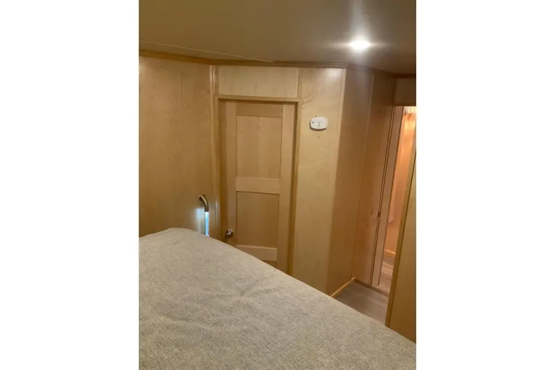 Slide: The Image of Interior of 2023 Sumerset 18 x 81 houseboat, featuring wooden walls and cozy lighting. - 61