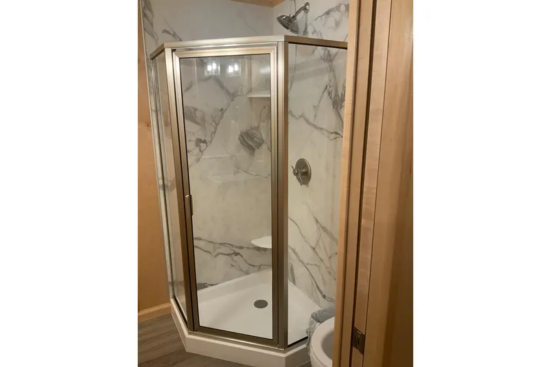 Slide: The Image of Modern shower with glass door and marble walls in 2023 Sumerset 18 x 81 houseboat. - 62