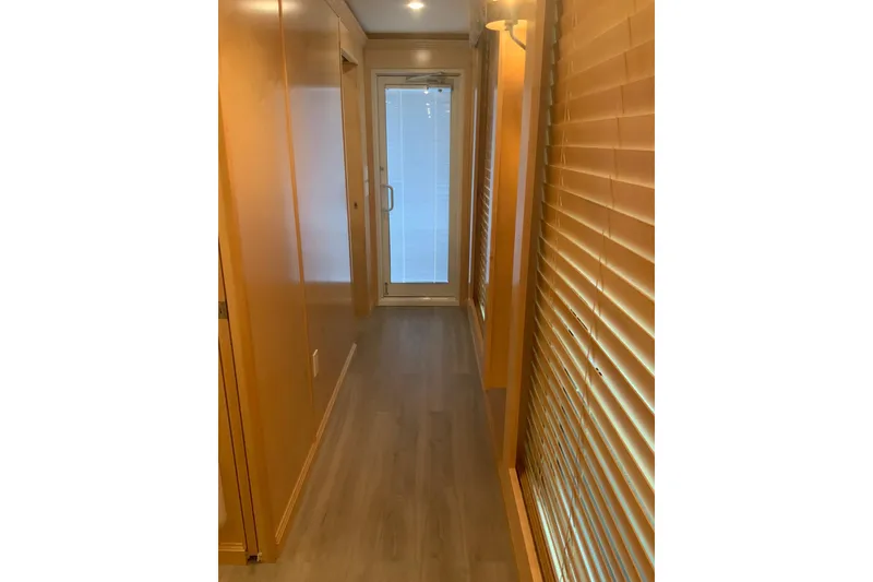 Slide: The Image of Narrow hallway in 2023 Sumerset 18 x 81 houseboat with wooden blinds and flooring. - 65