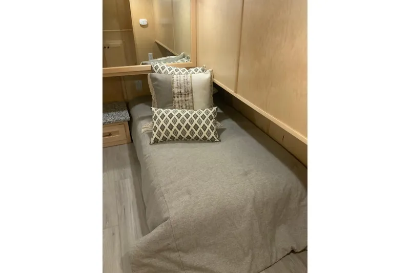 Slide: The Image of Cozy bedroom in 2023 Sumerset 18 x 81 houseboat with stylish pillows and wood paneling. - 69