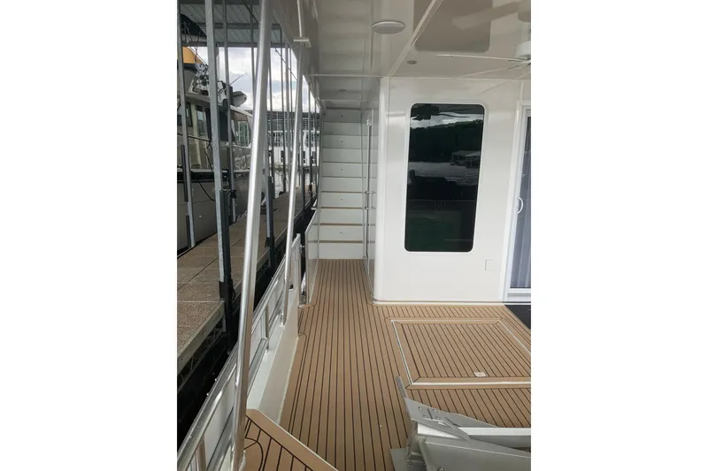 Slide: The Image of Modern Sumerset 18 x 81 houseboat deck with sleek design and wood flooring, 2023 model. - 7