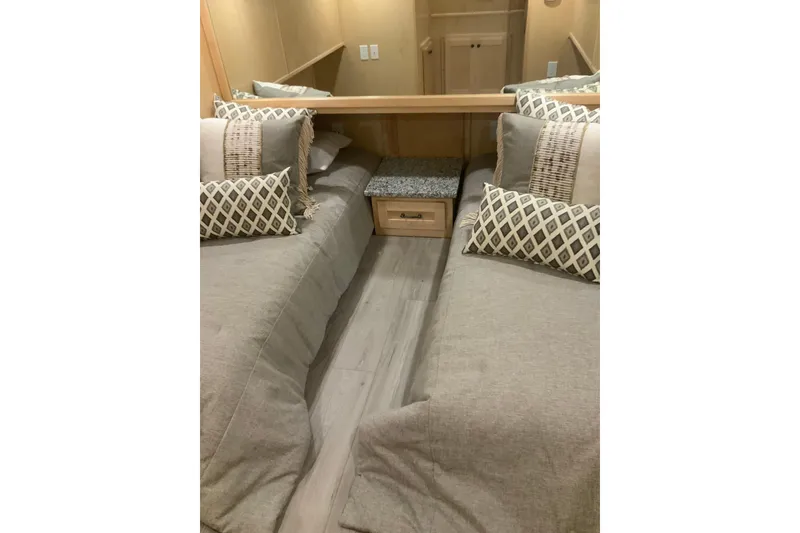 Slide: The Image of Interior of 2023 Sumerset 18 x 81 houseboat with twin beds and decorative pillows. - 70