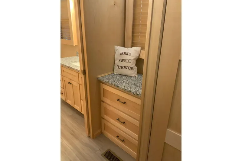 Slide: The Image of Interior of 2023 Sumerset 18 x 81 houseboat with wooden cabinets and decorative pillow. - 75