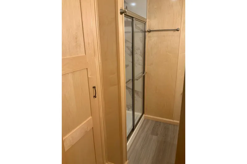 Slide: The Image of Modern bathroom with wooden cabinetry and glass shower in 2023 Sumerset 18 x 81 houseboat. - 77