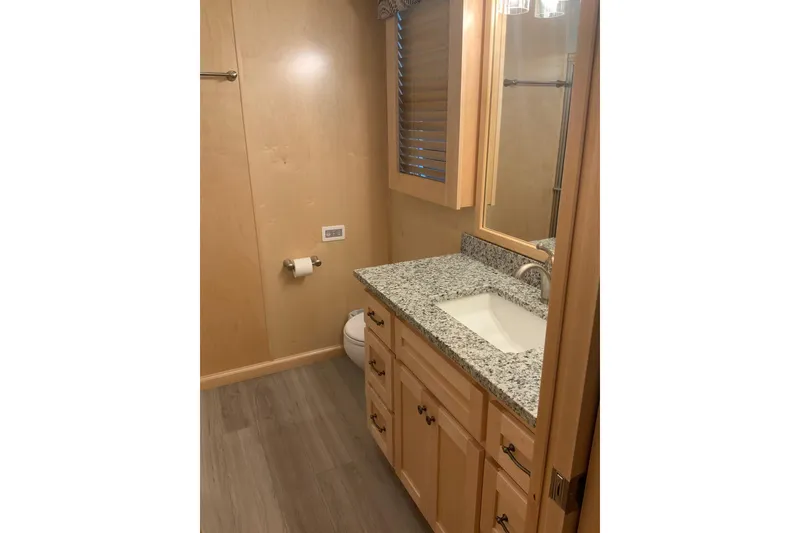 Slide: The Image of Modern bathroom in 2023 Sumerset 18 x 81 houseboat with granite countertop and wooden cabinetry. - 78