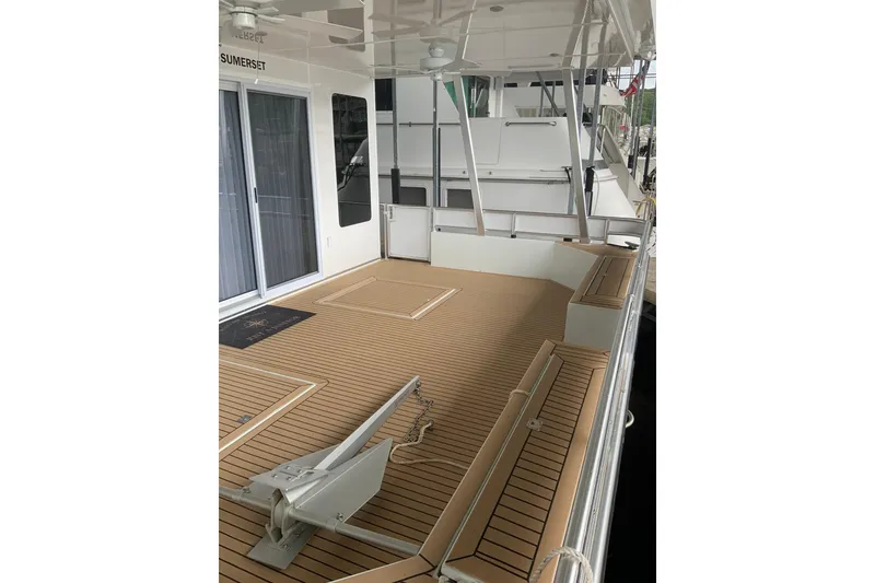 Slide: The Image of 2023 Sumerset 18 x 81 houseboat deck with modern design and wood finish. - 8