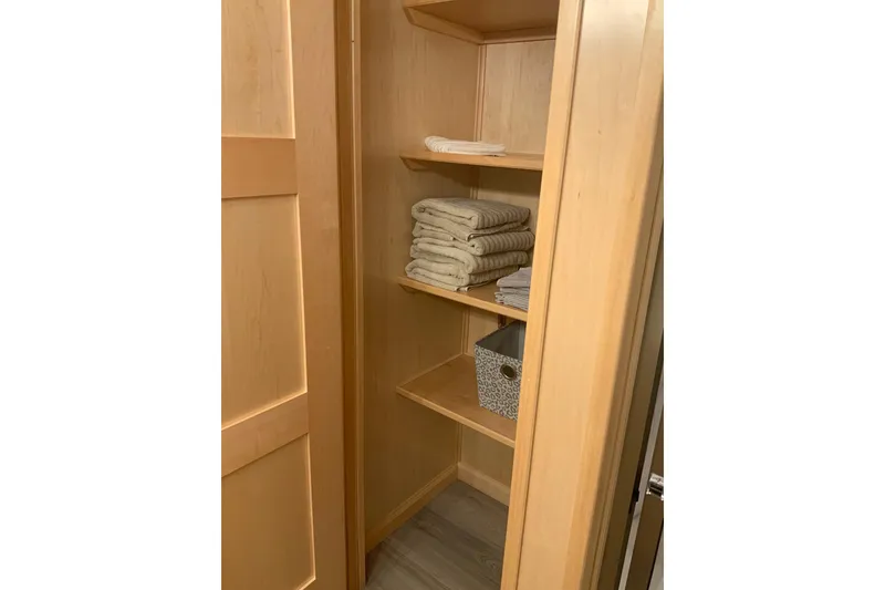 Slide: The Image of Wooden closet with neatly stacked towels and a storage basket, Sumerset 18 x 81, 2023 model. - 80