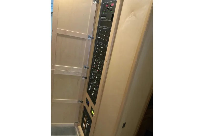 Slide: The Image of Electrical panel inside a 2023 Sumerset 18 x 81 houseboat, featuring control switches and indicators. - 84